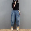 S5f66127358d4435f8f49633715198d29v.webp Pantalon harem en jean oversize pour femme, taille élastique, jambes larges, délavé, coupe ample, style rétro streetwear