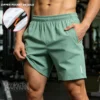S80b9b1ff492a4445a14b10171b653f4fq.webp Short d'été pour homme, taille UE, vêtement de sport tendance pour la course à pied, short décontracté pour la salle de sport, le fitness et le jogging, blanc
